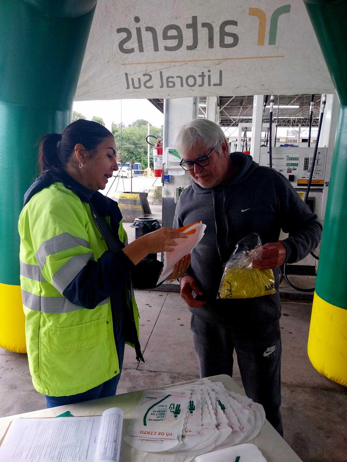 Entrega e orientação ao motorista sobre segurança no trânsito.